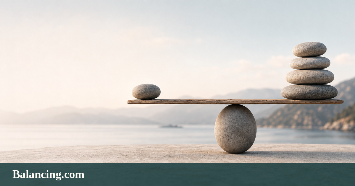 A wooden beam balanced on a rounded stone, with one river stone opposite a carefully stacked group